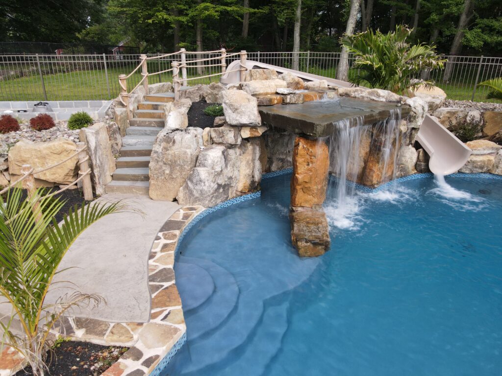 inground swimming pool with custom rockwork and waterfalls